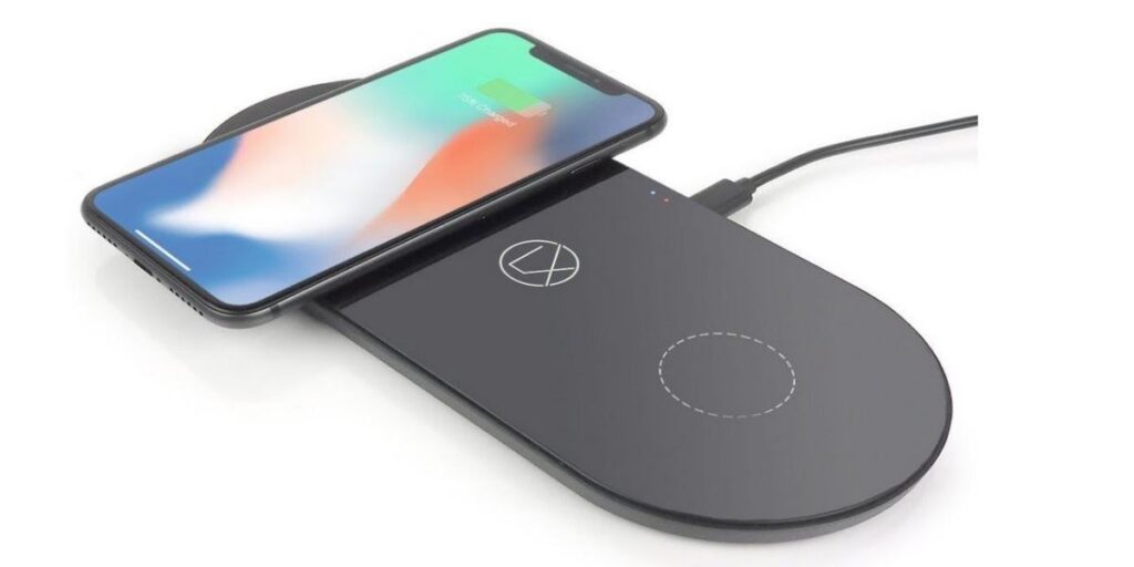 A smartphone displaying a 75% charge is placed on a black dual wireless charging pad.